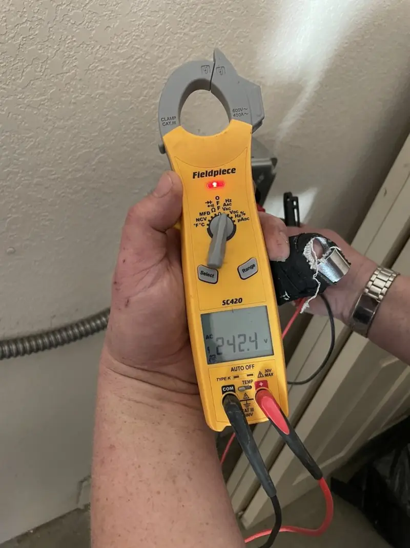 Voltage testing with clamp meter during Electrical Installation Services in Jesup